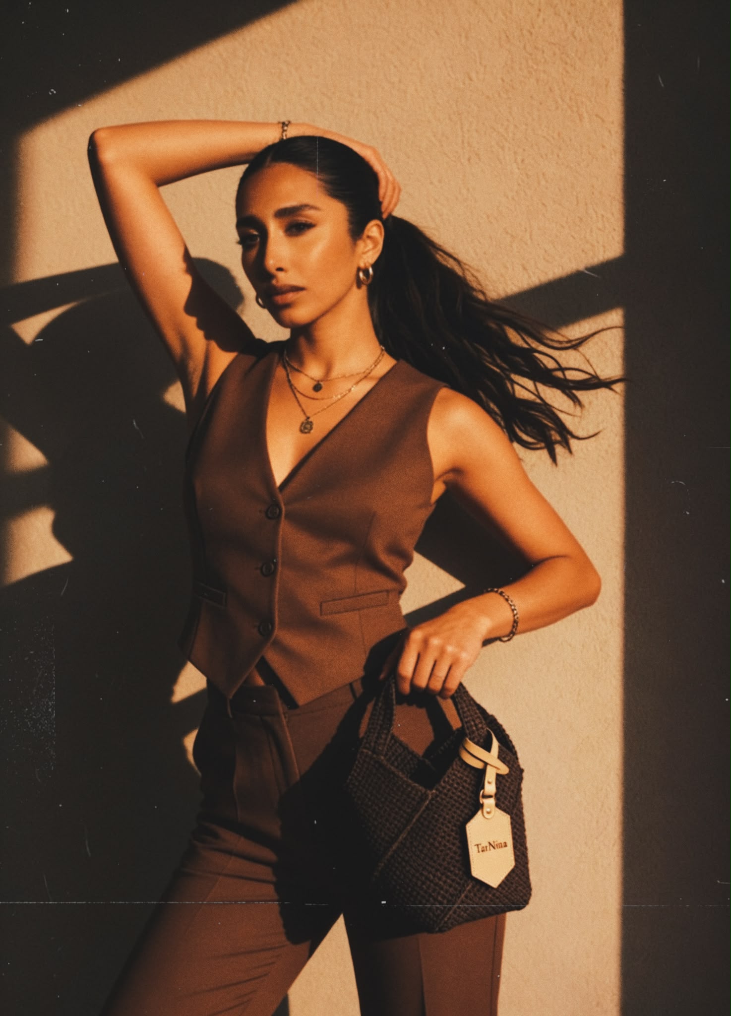 Nina carrying a handcrafted TarNina bag in warm golden light — from the TarNina editorial campaign